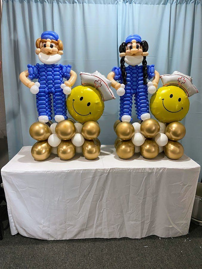Three balloons are sitting on top of each other on a table.