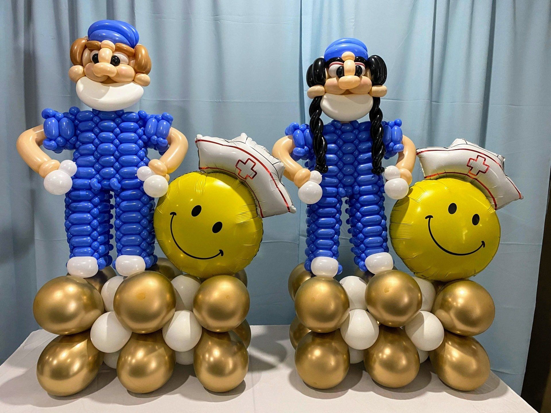 Three balloons are sitting on top of each other on a table.