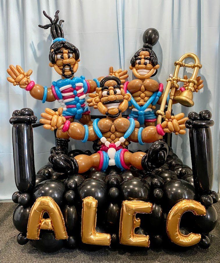 A balloon sculpture of a band with the name alec on it.