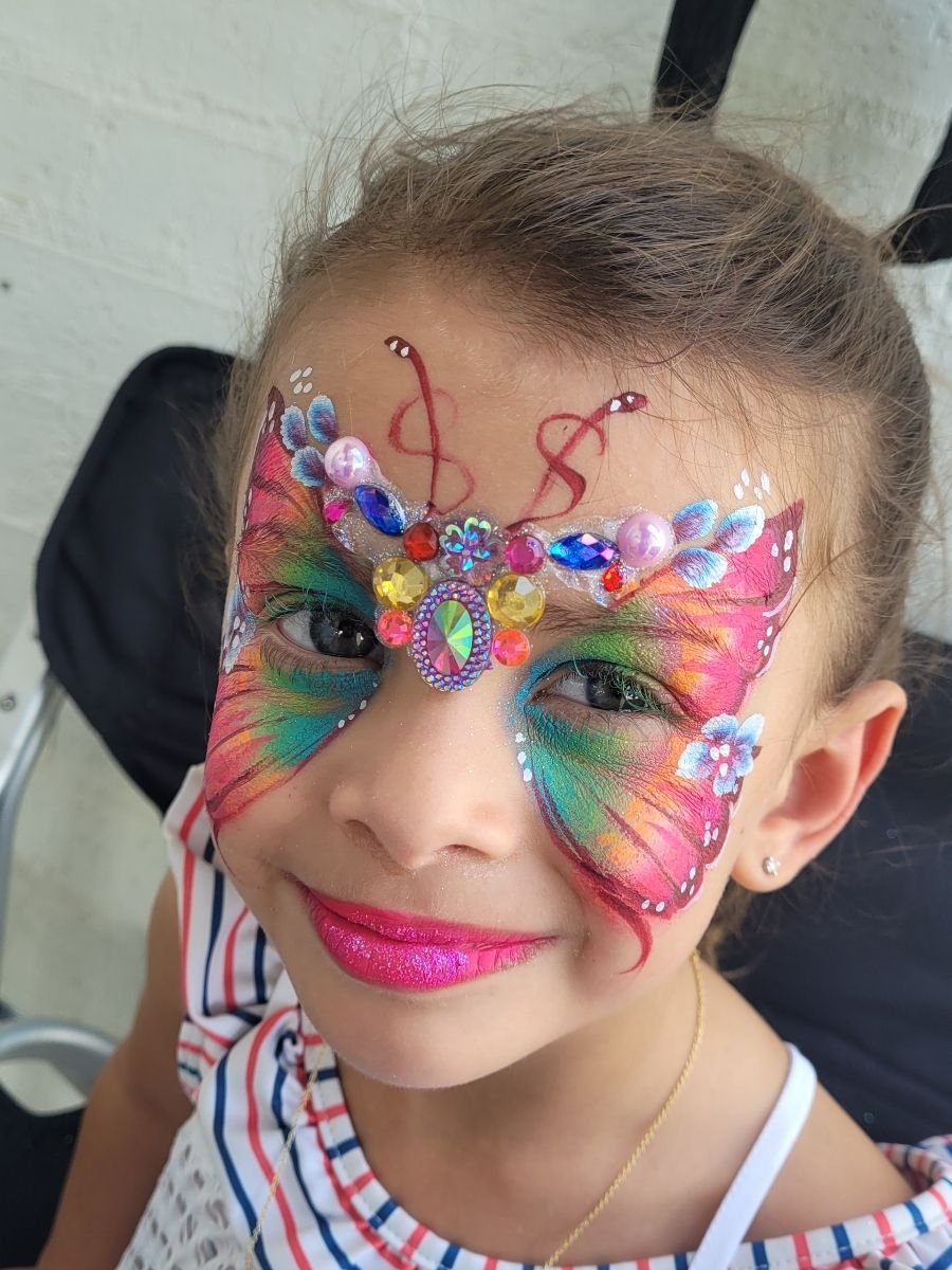 A little girl with a butterfly painted on her face