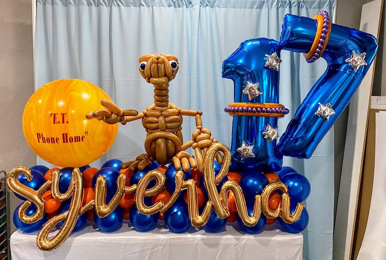 A table topped with balloons and a skeleton balloon.