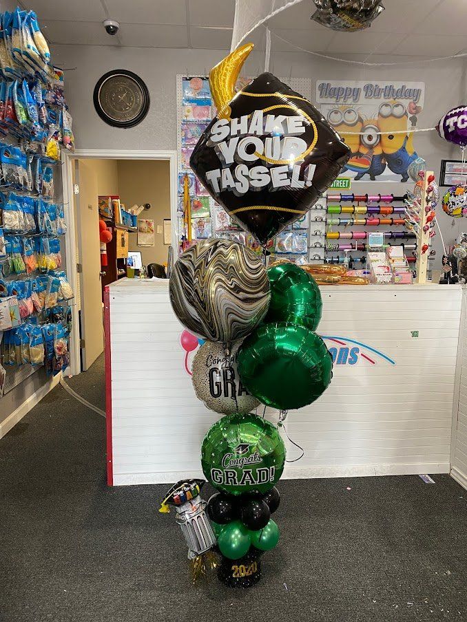 A bunch of balloons are sitting on a table in a store.