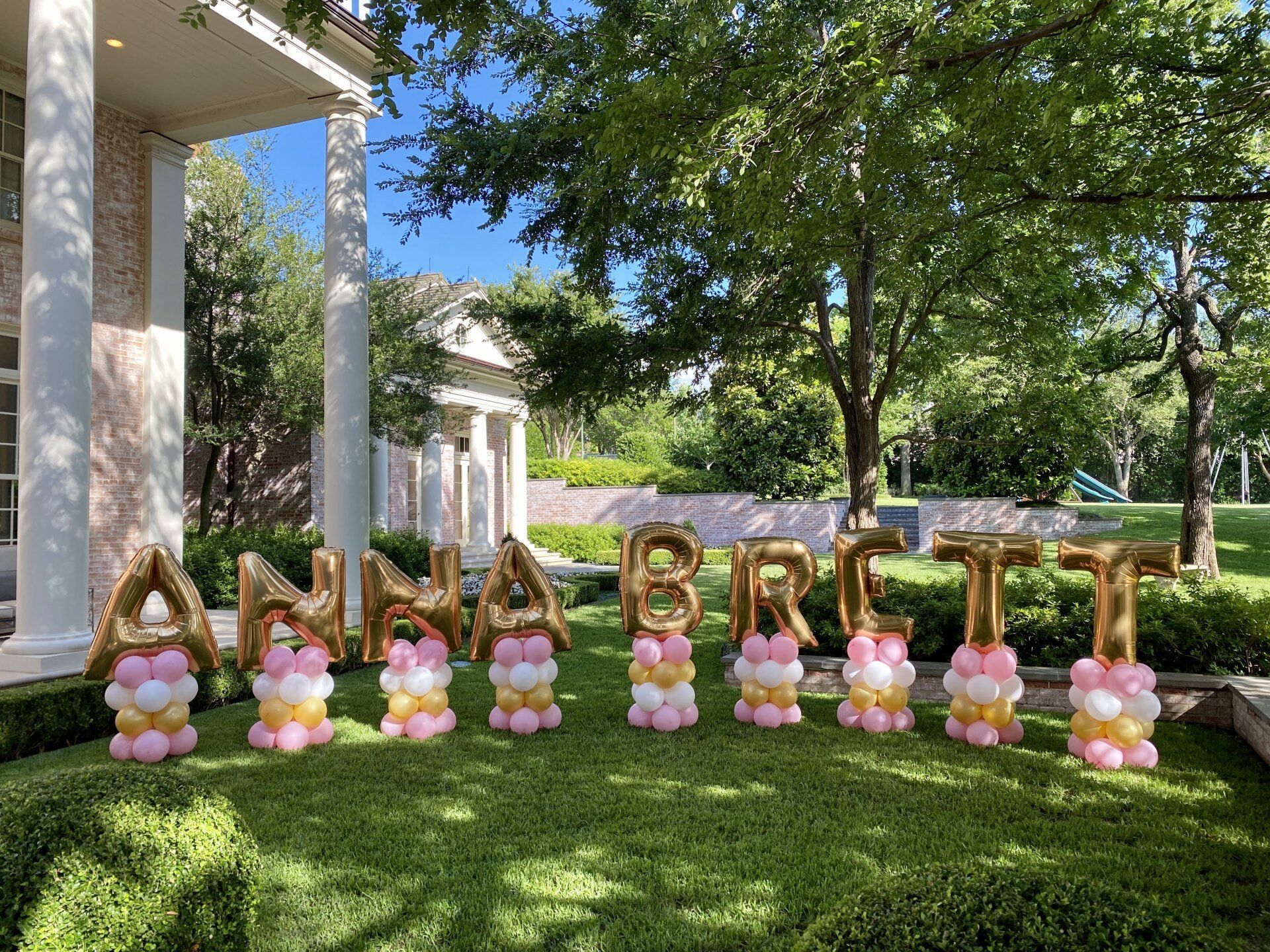 A row of balloons spelling out the name anna britt.