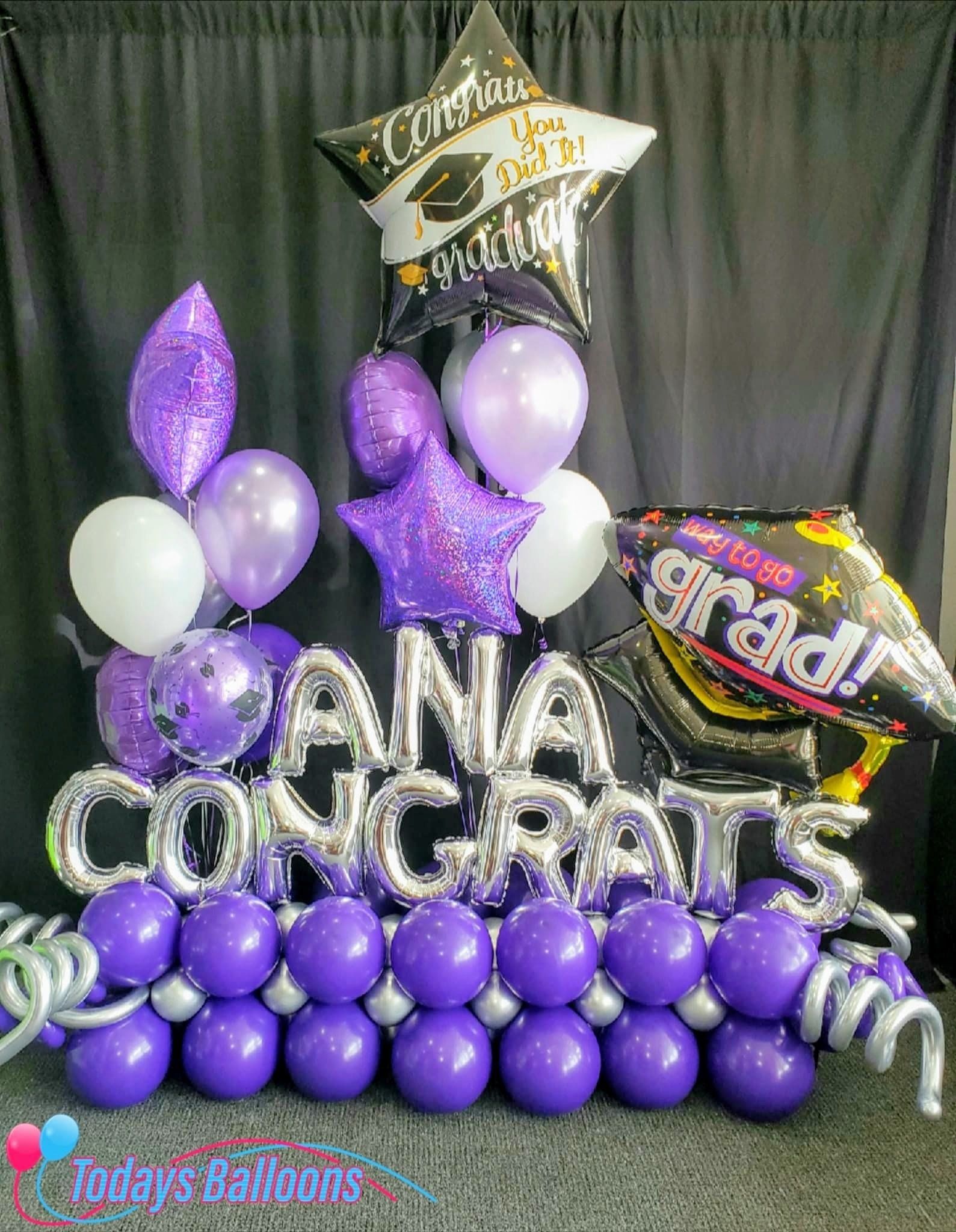 A bunch of purple balloons are sitting on top of each other on a table.