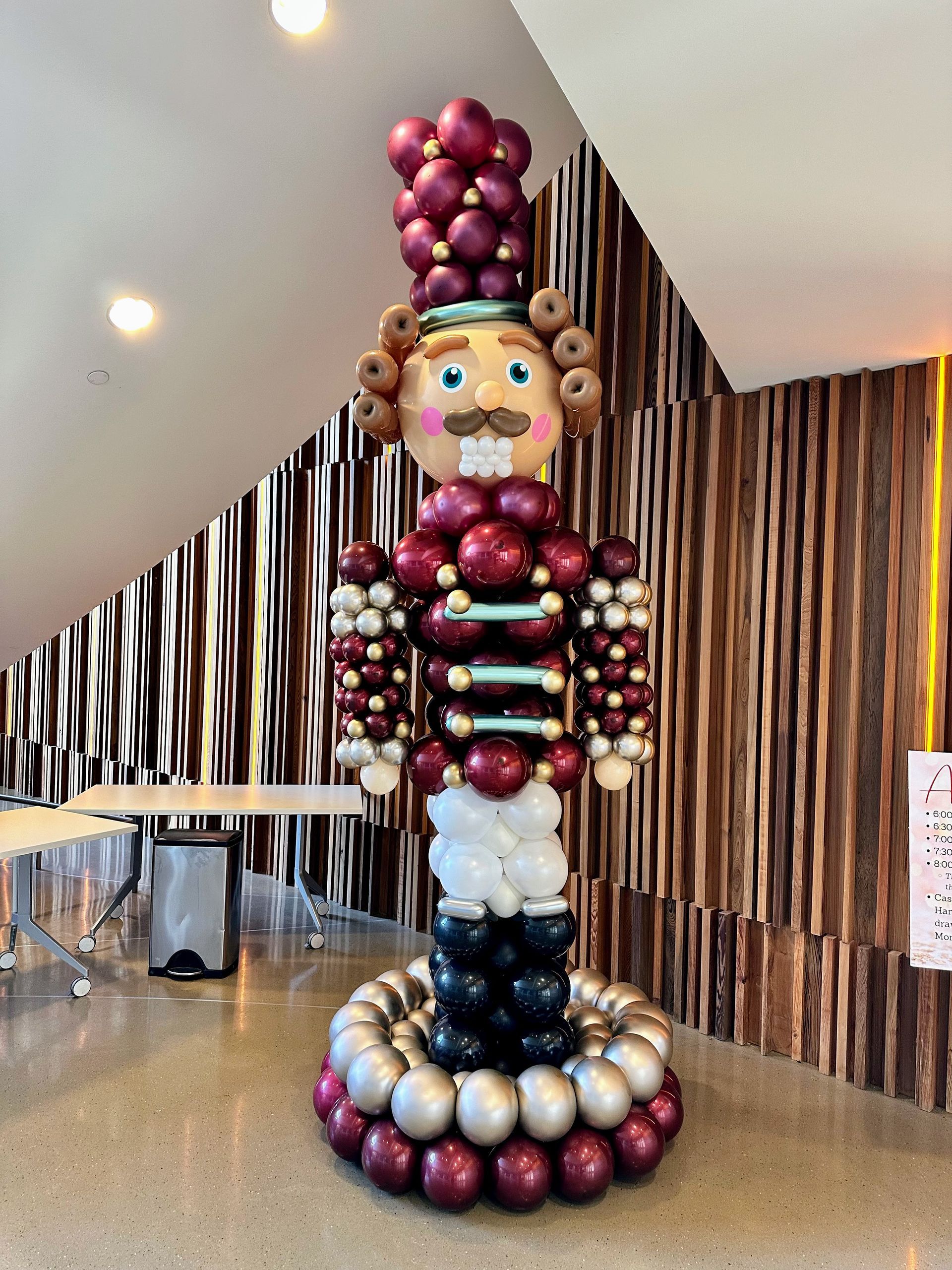 A nutcracker made out of balloons in a room