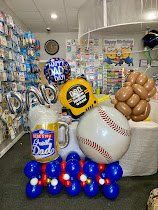 A bunch of balloons are sitting on top of a table in a store.