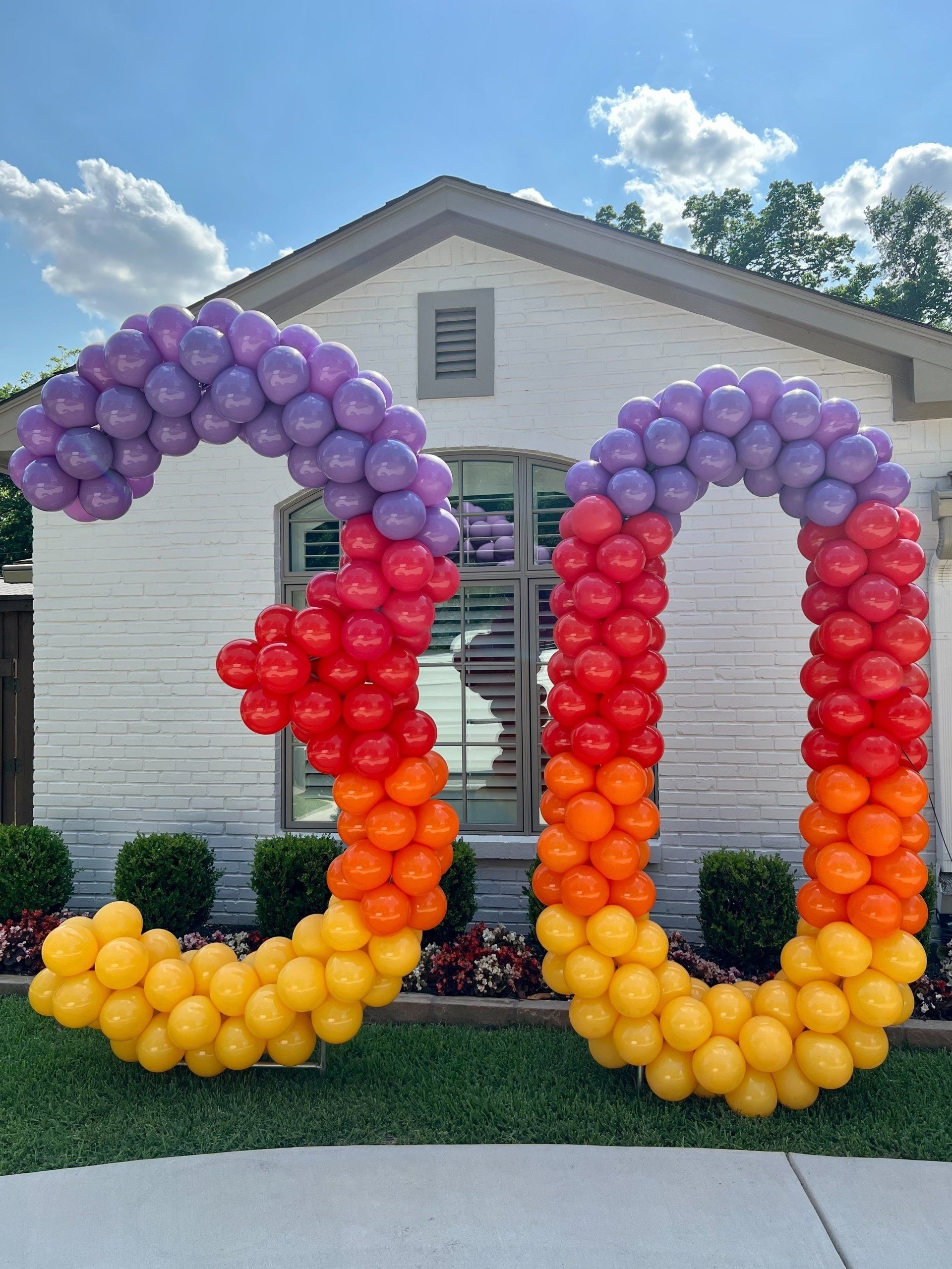 A large number 30 made of balloons in front of a house.