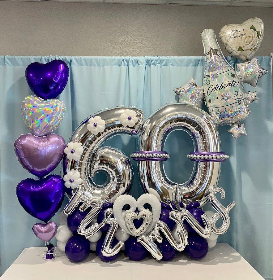 A bunch of balloons with the number 60 on them