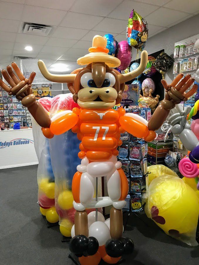 A bull made out of balloons has the number 77 on his jersey