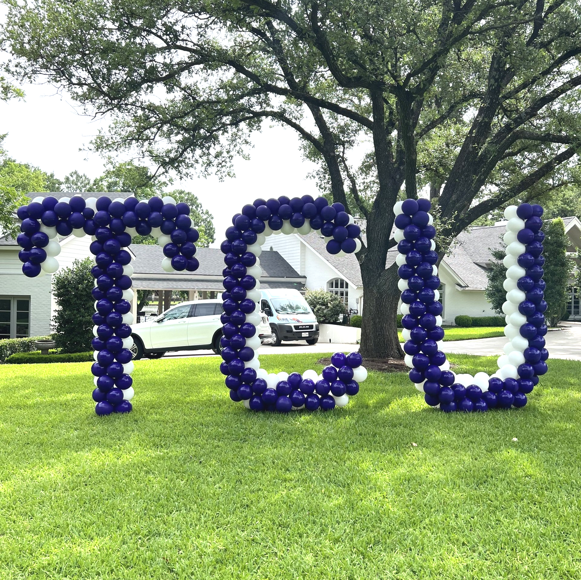 The word tcu is made out of purple and white balloons.