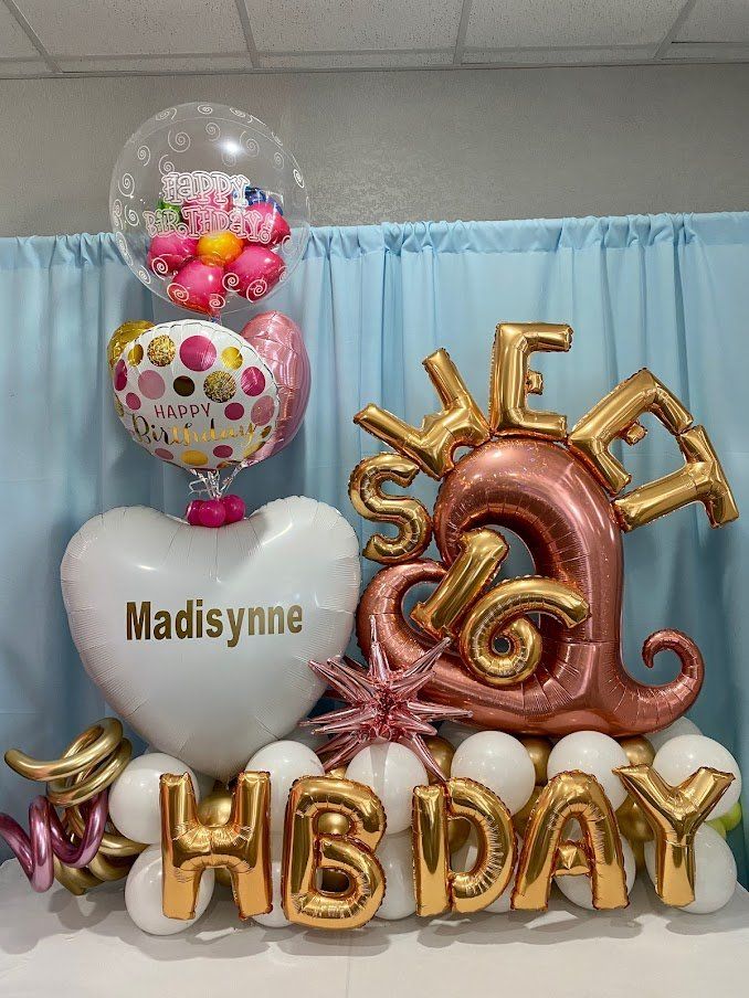 A bunch of balloons are sitting on top of each other on a table.