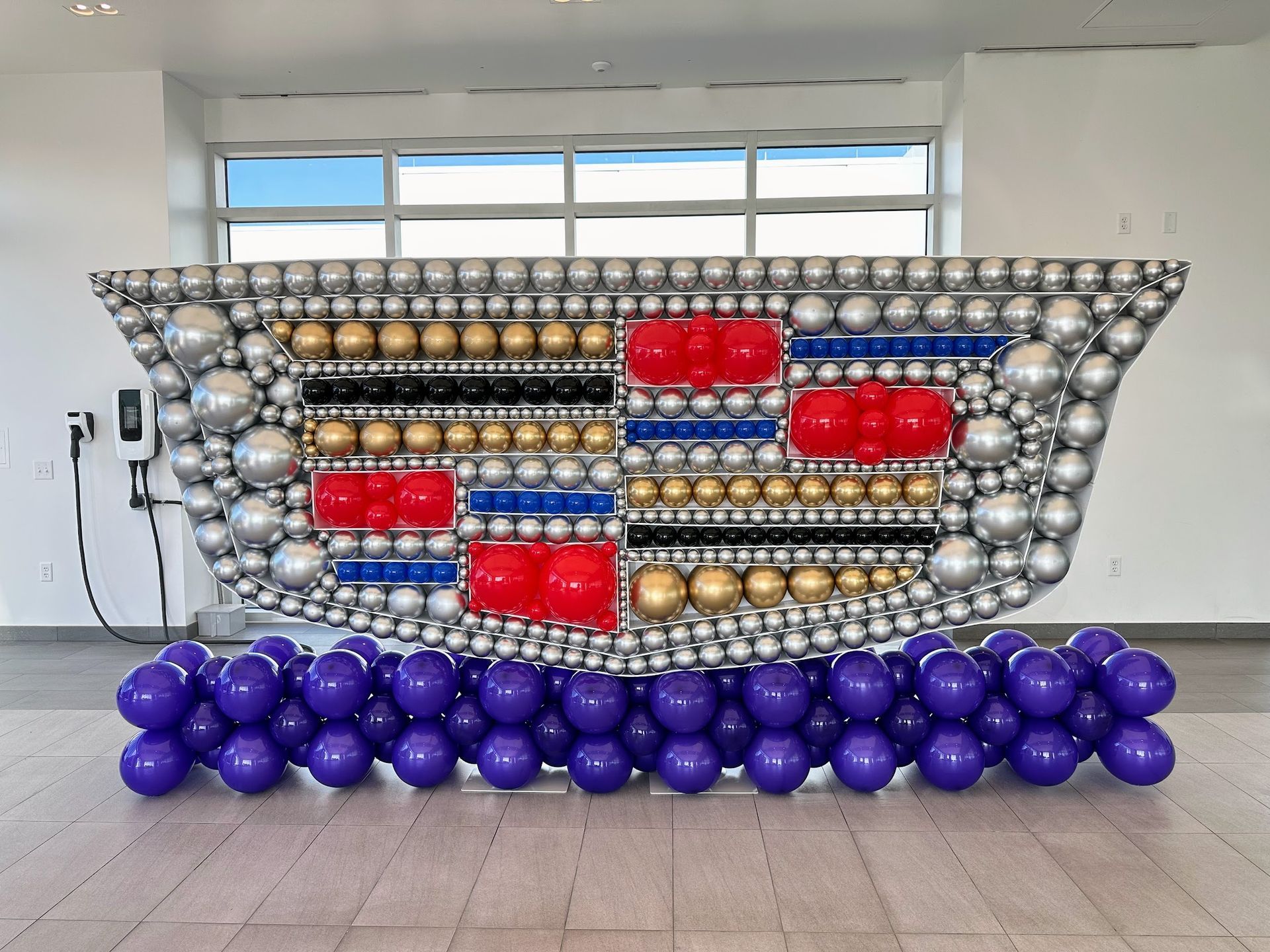 A large sculpture made out of balloons in a room