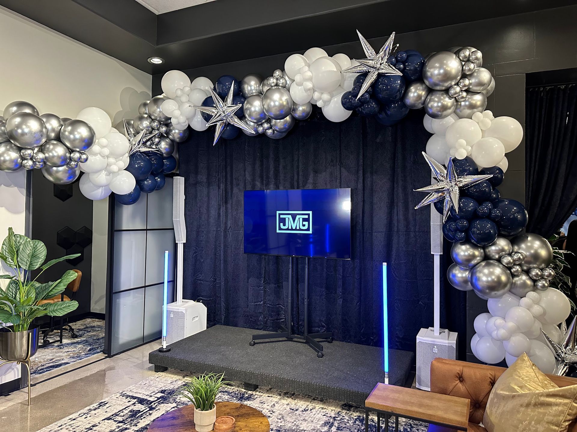 Elegant silver and white balloon arch entrance for corporate networking or business mixer event