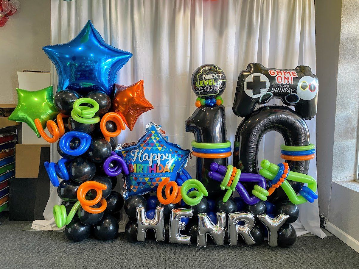 A bunch of balloons with the name henry on them