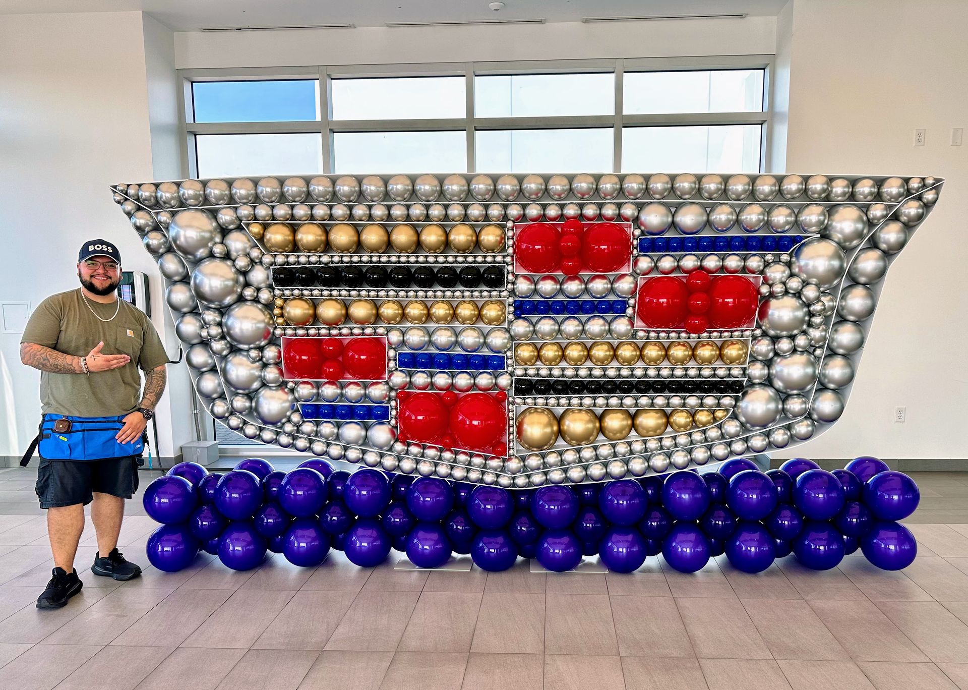 Organic balloon arch installation with mixed balloon sizes for corporate event entrance