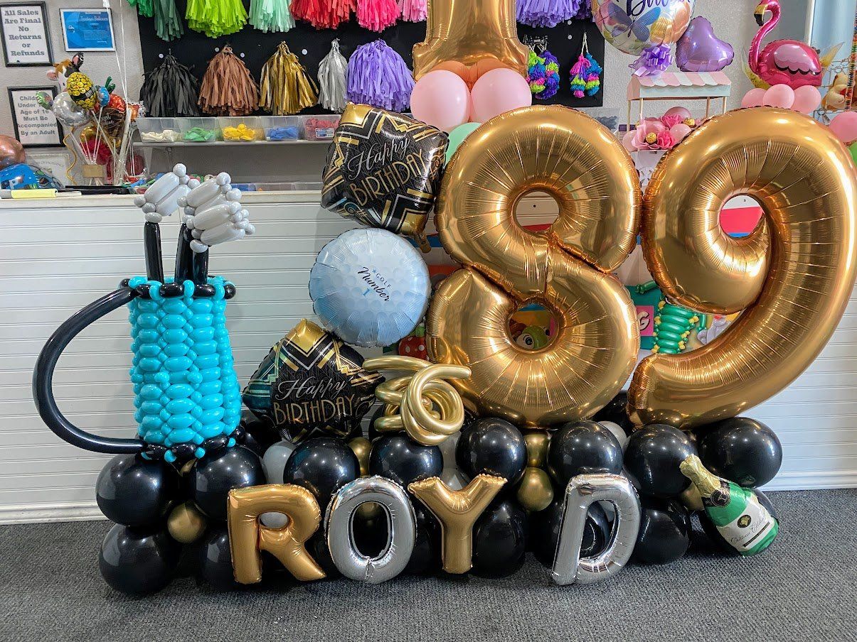 A bunch of balloons are sitting on top of each other in a room.