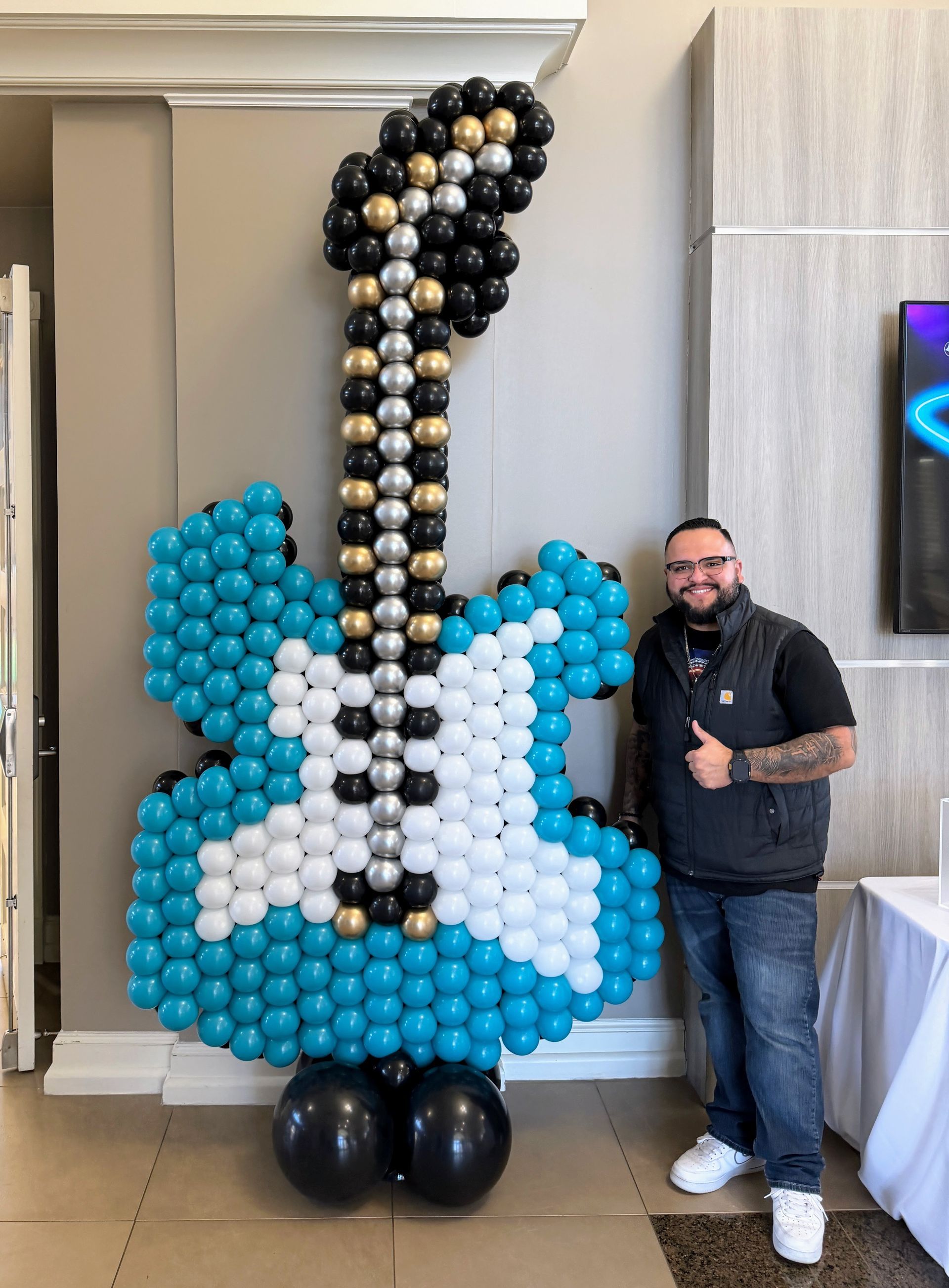 Valentine’s Day love balloon wall with gold letters and red garland by Today's Balloons Fort Worth