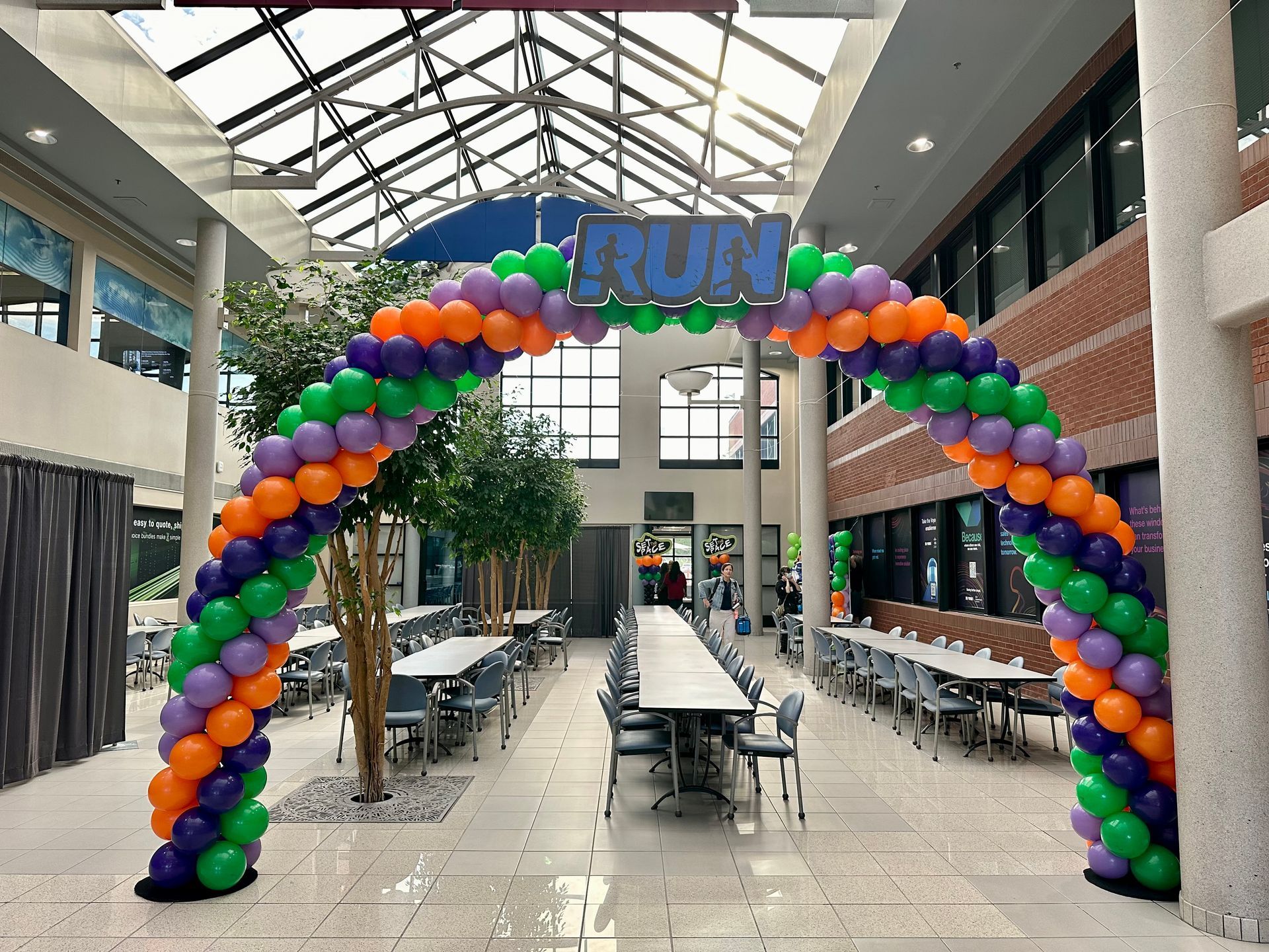 A large arch of balloons with the word run on it
