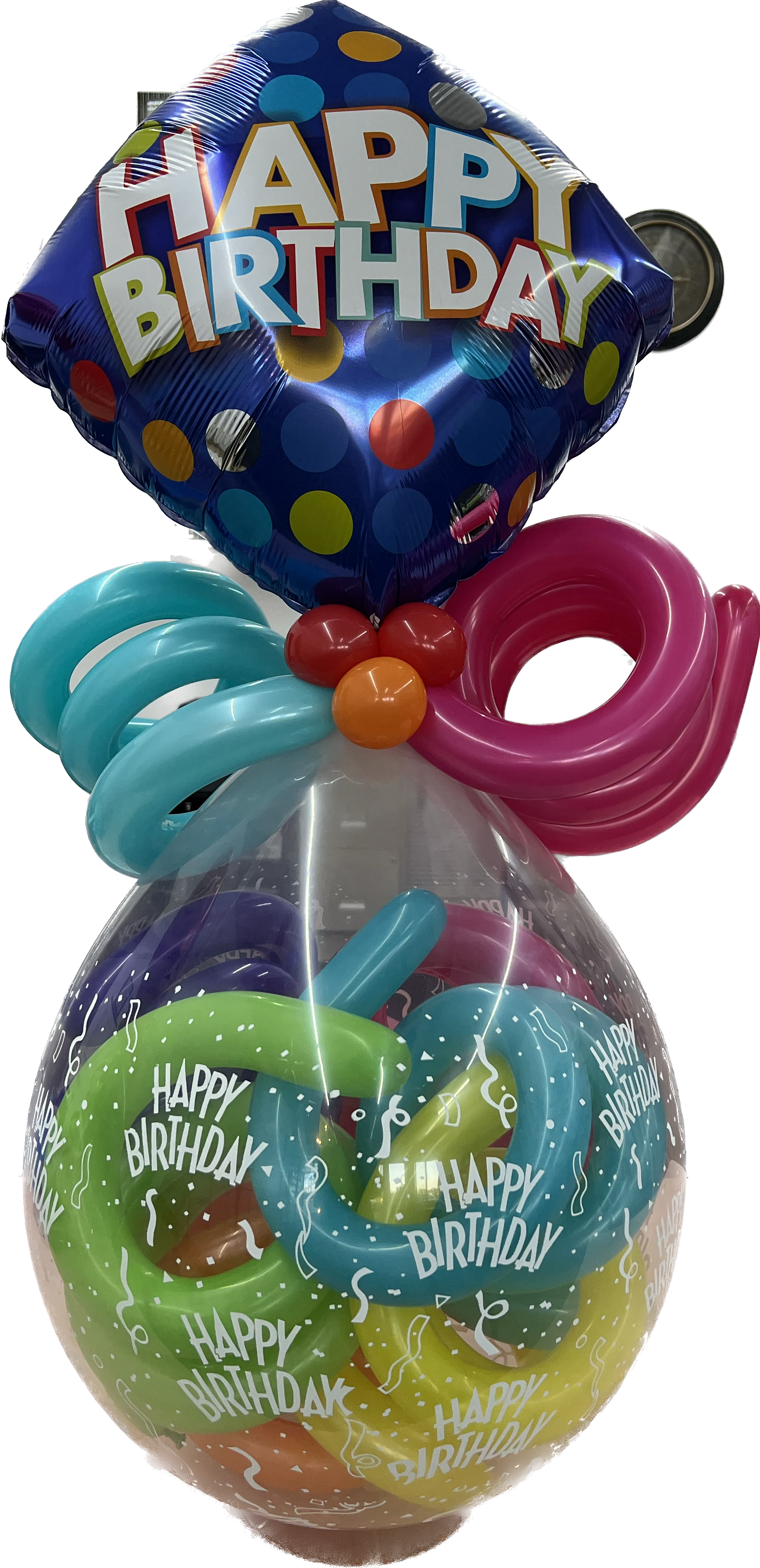 A happy birthday balloon is sitting on top of a balloon filled with balloons.