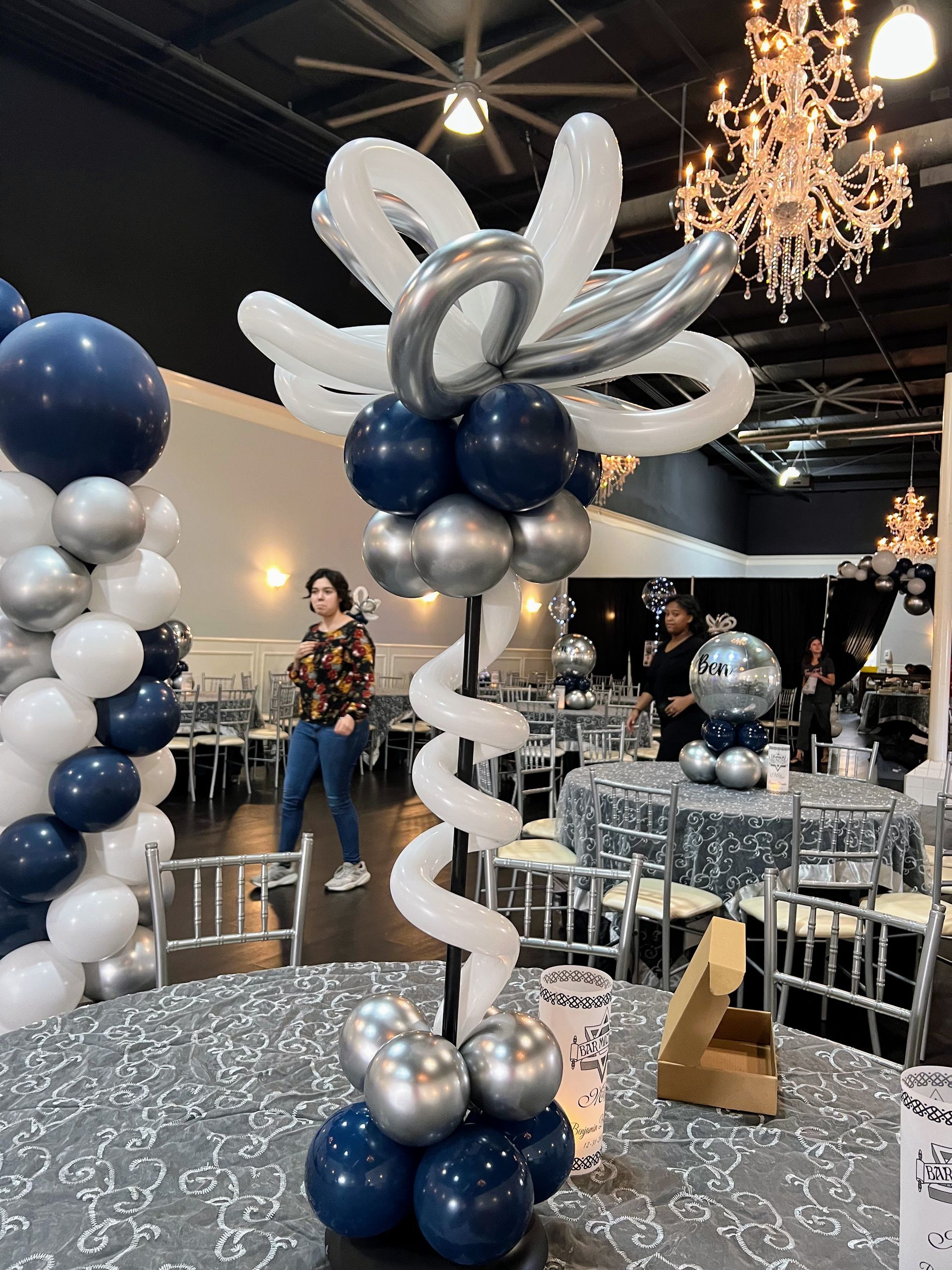 A bunch of balloons are sitting on top of a table in a room.
