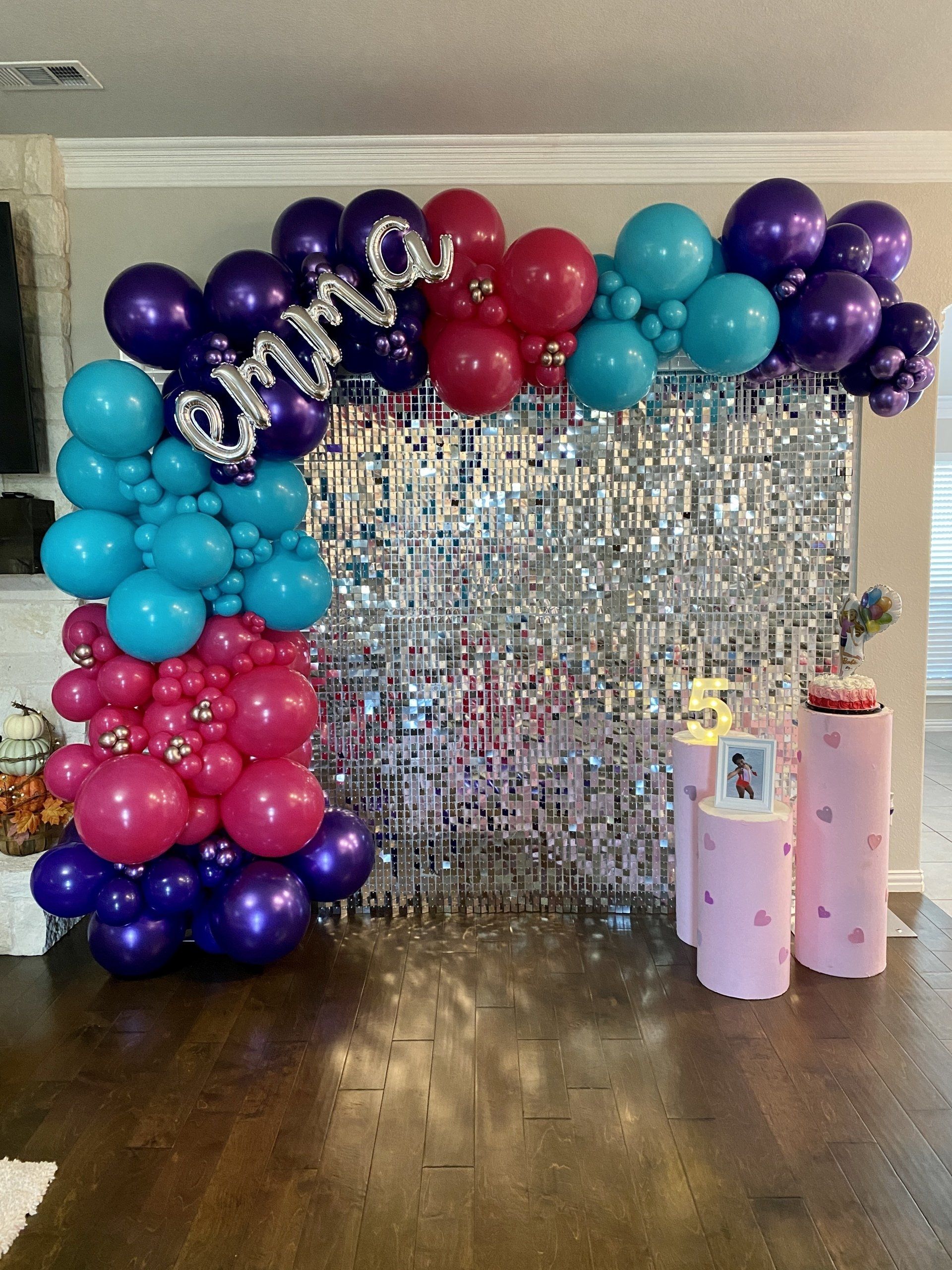 A room filled with balloons and a shimmering wall.