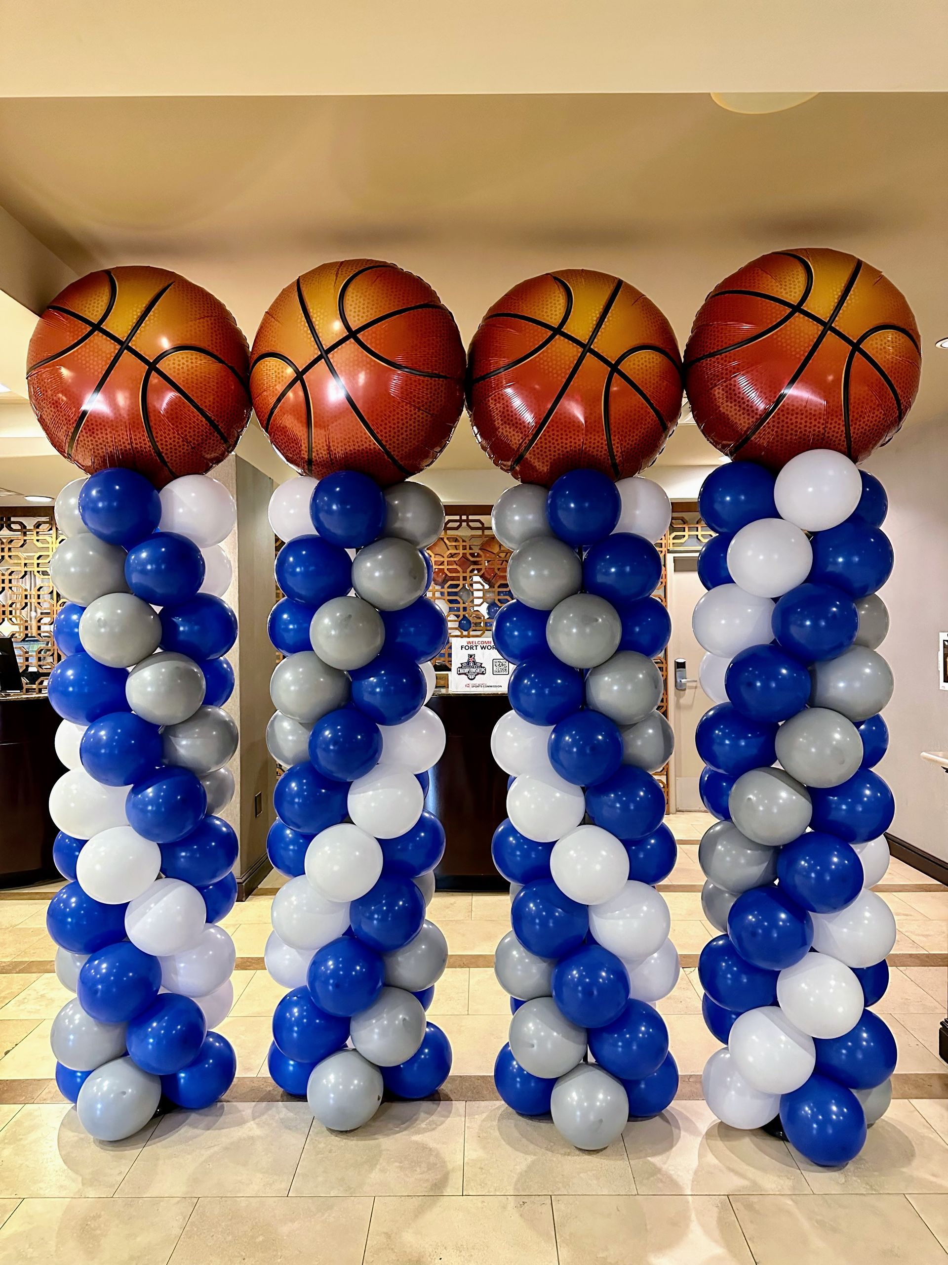A row of balloons with basketballs on top of them