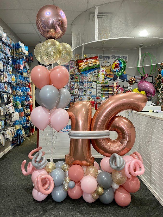 A bunch of balloons are sitting on a table in a store.