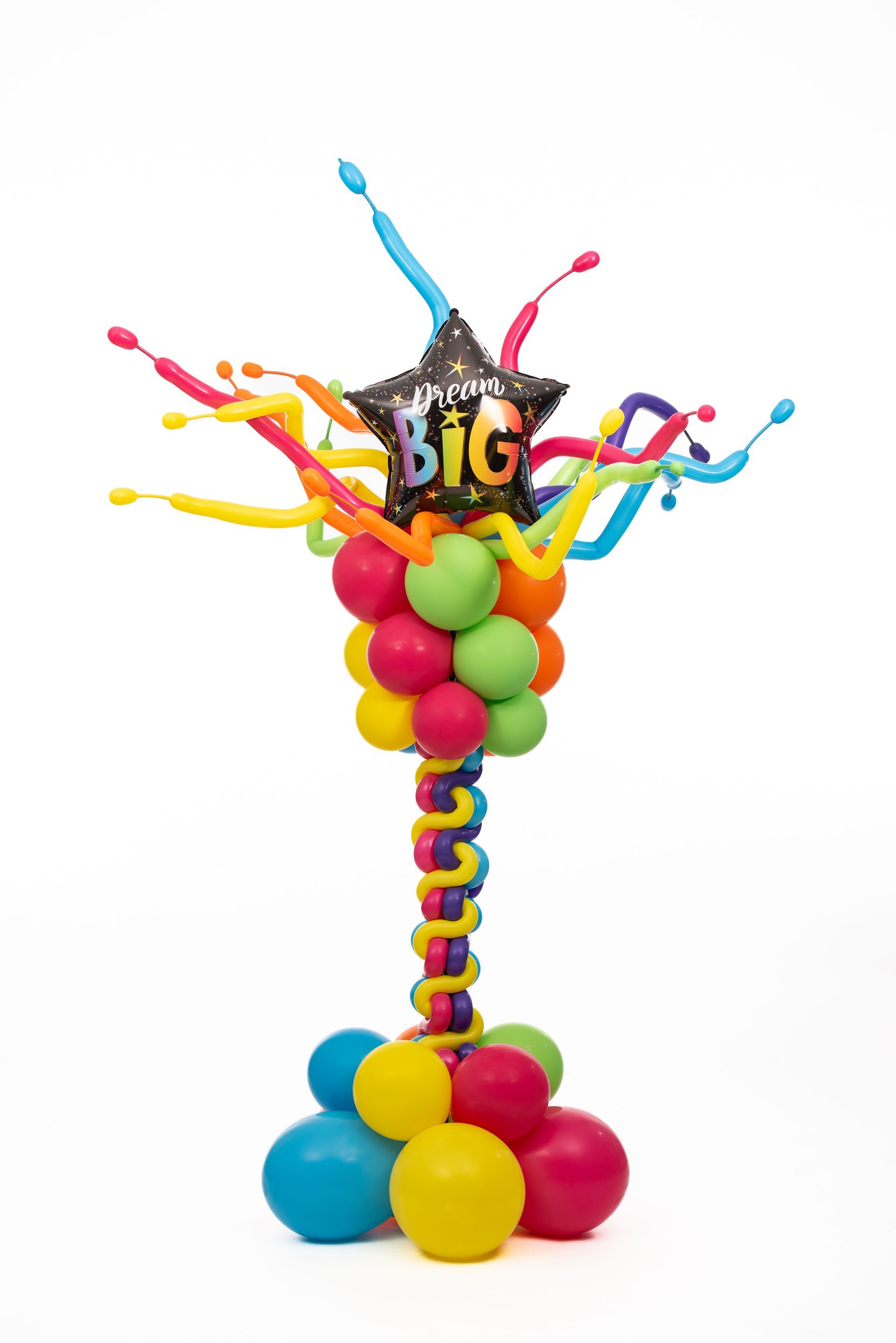 A bunch of colorful balloons are stacked on top of each other on a white background.