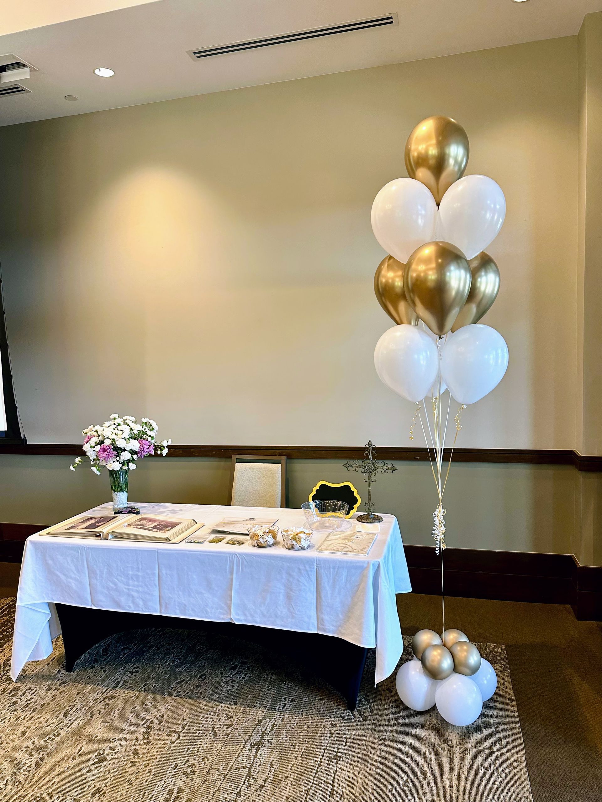 A festive birthday balloon bouquet featuring a large, starry blue foil star balloon with 