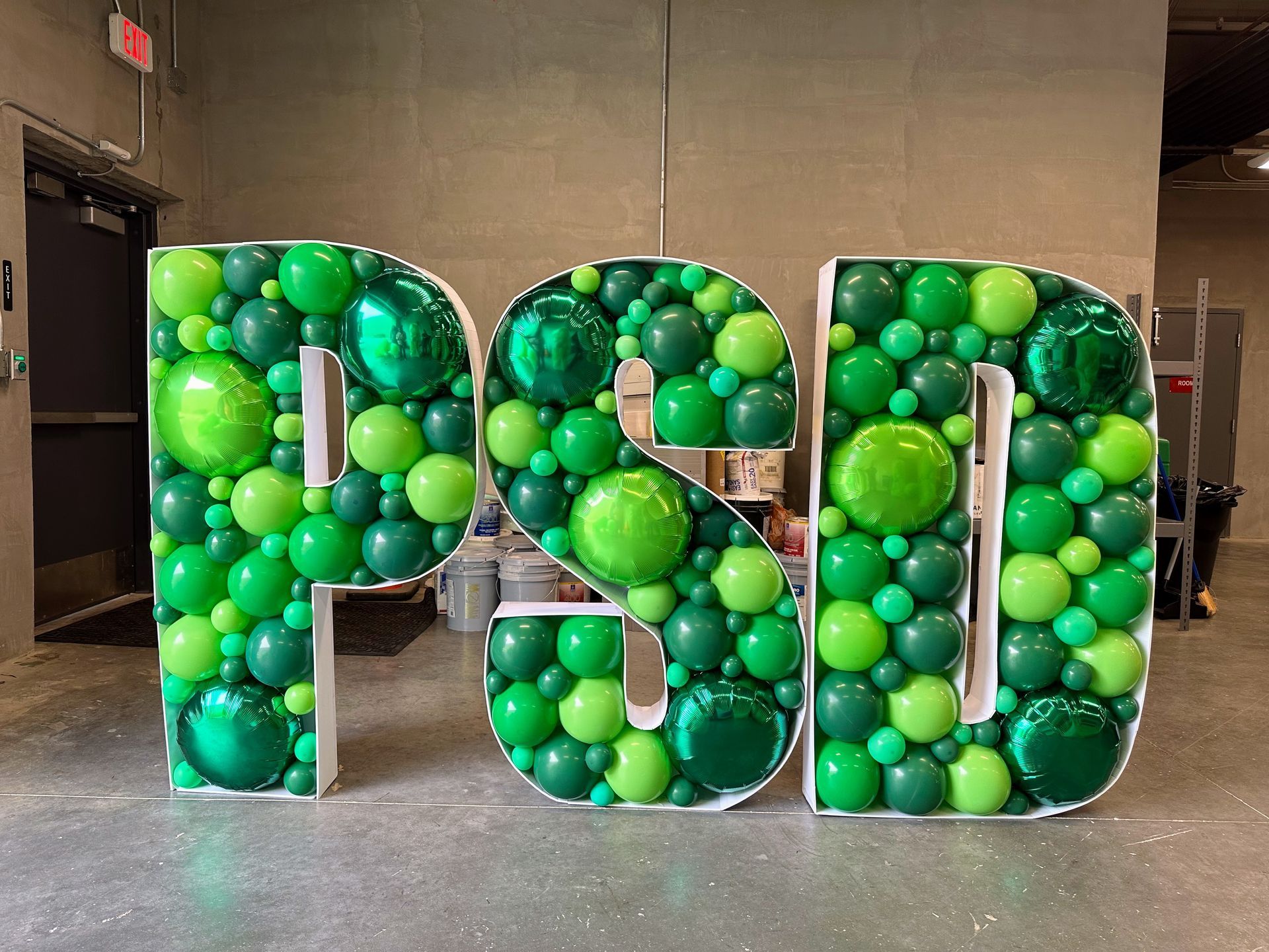 The word psd is made out of green balloons.