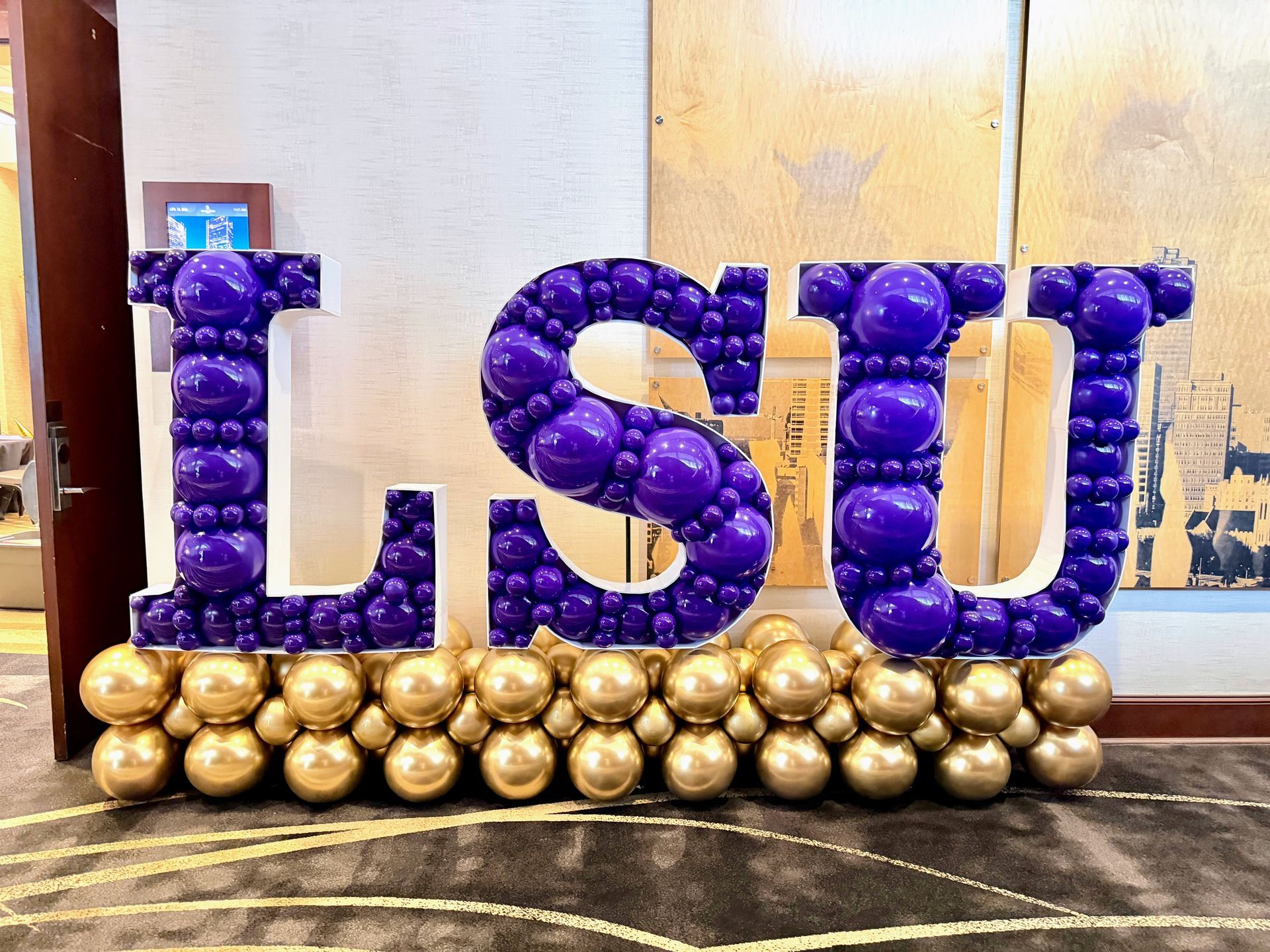 LSU balloon mosaic letters in purple and gold for school event decor in Fort Worth Texas