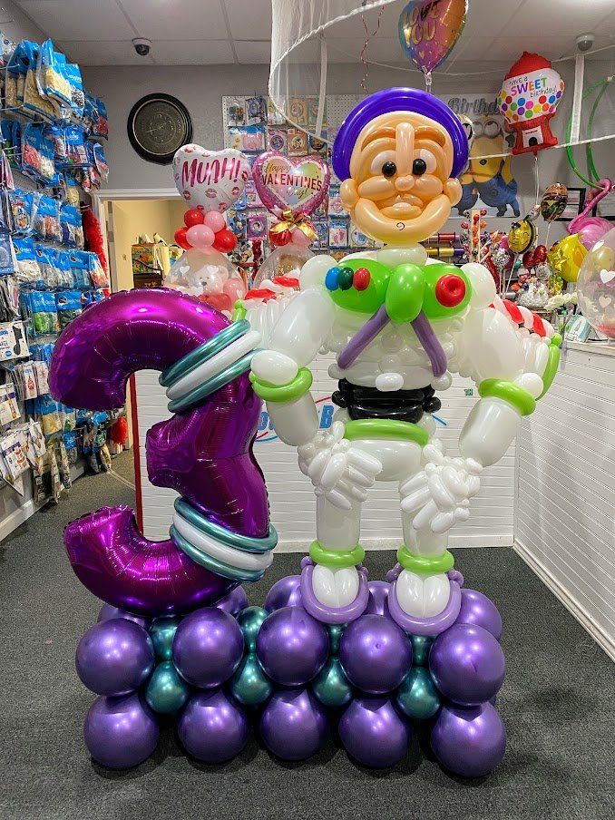 A balloon sculpture of buzz lightyear holding a purple number three.