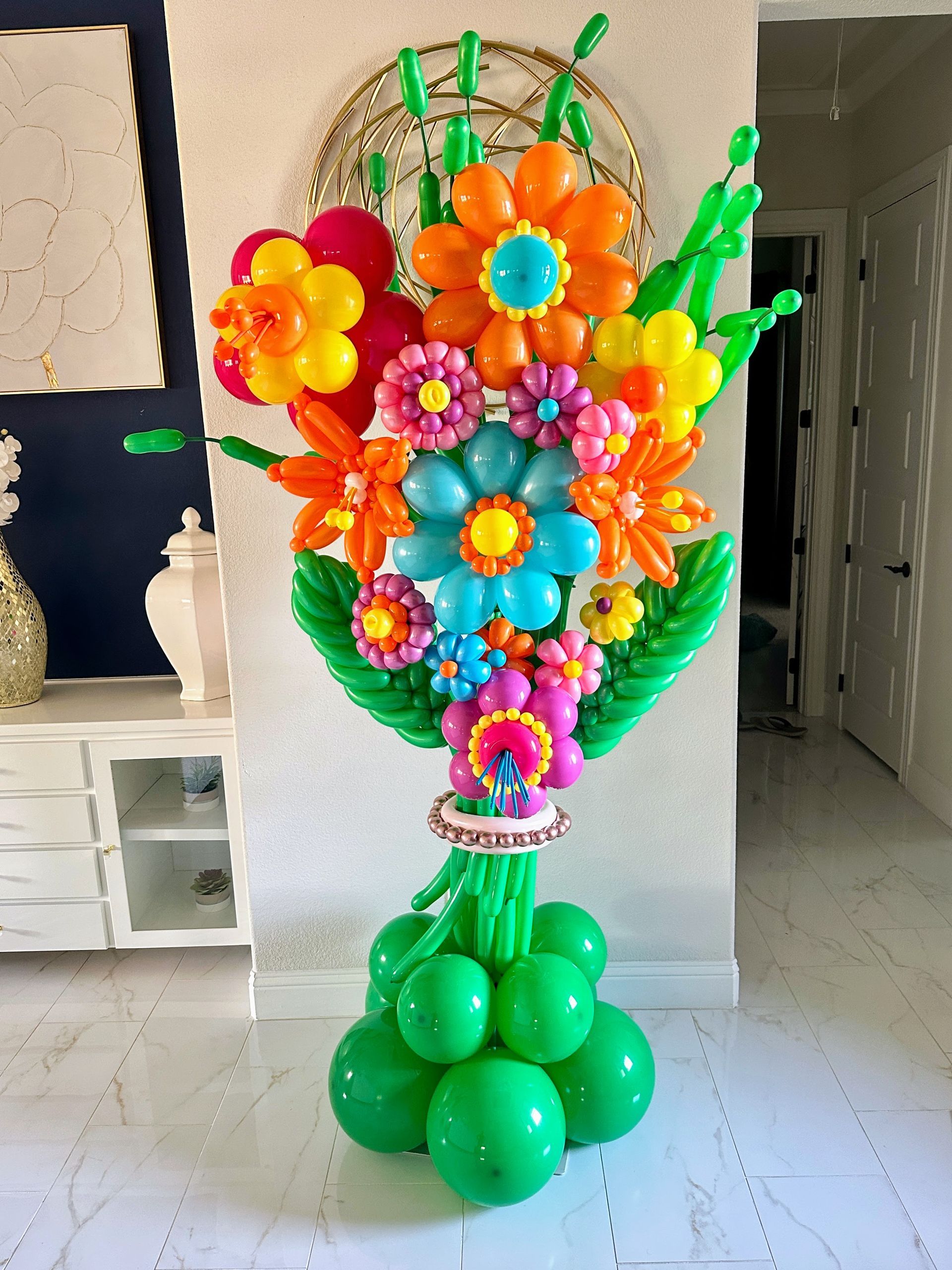 Floral balloon bouquet made with assorted balloon flowers and green balloon accents