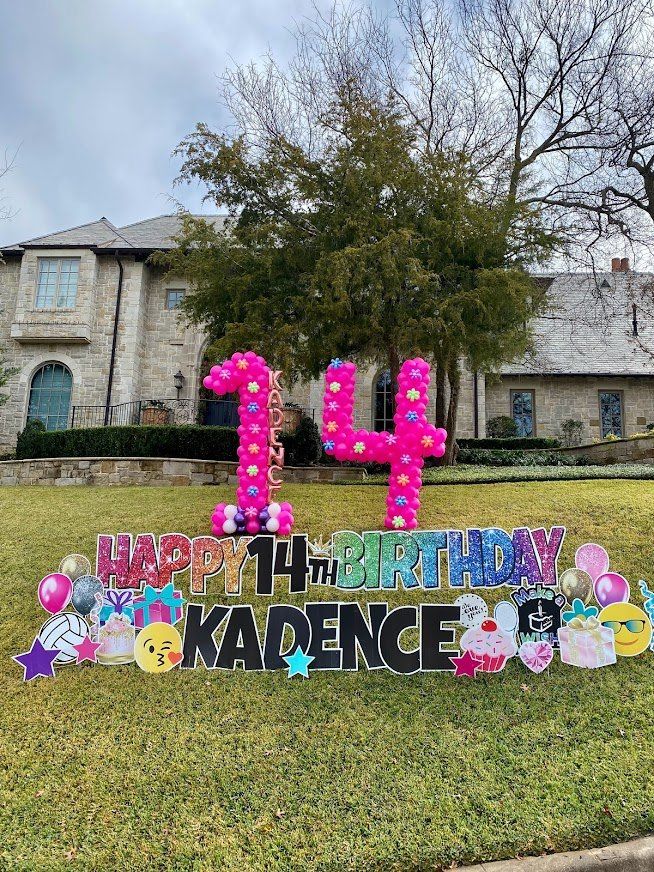 A happy 14th birthday sign is in front of a large house.