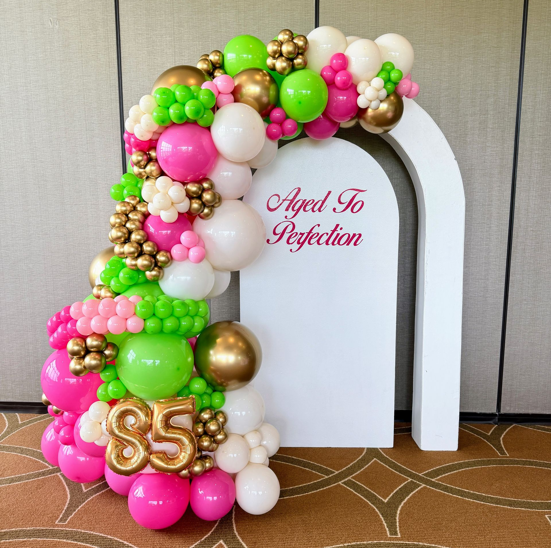 Balloon garland with pink floral theme for birthday backdrop and event decor in Fort Worth Texas