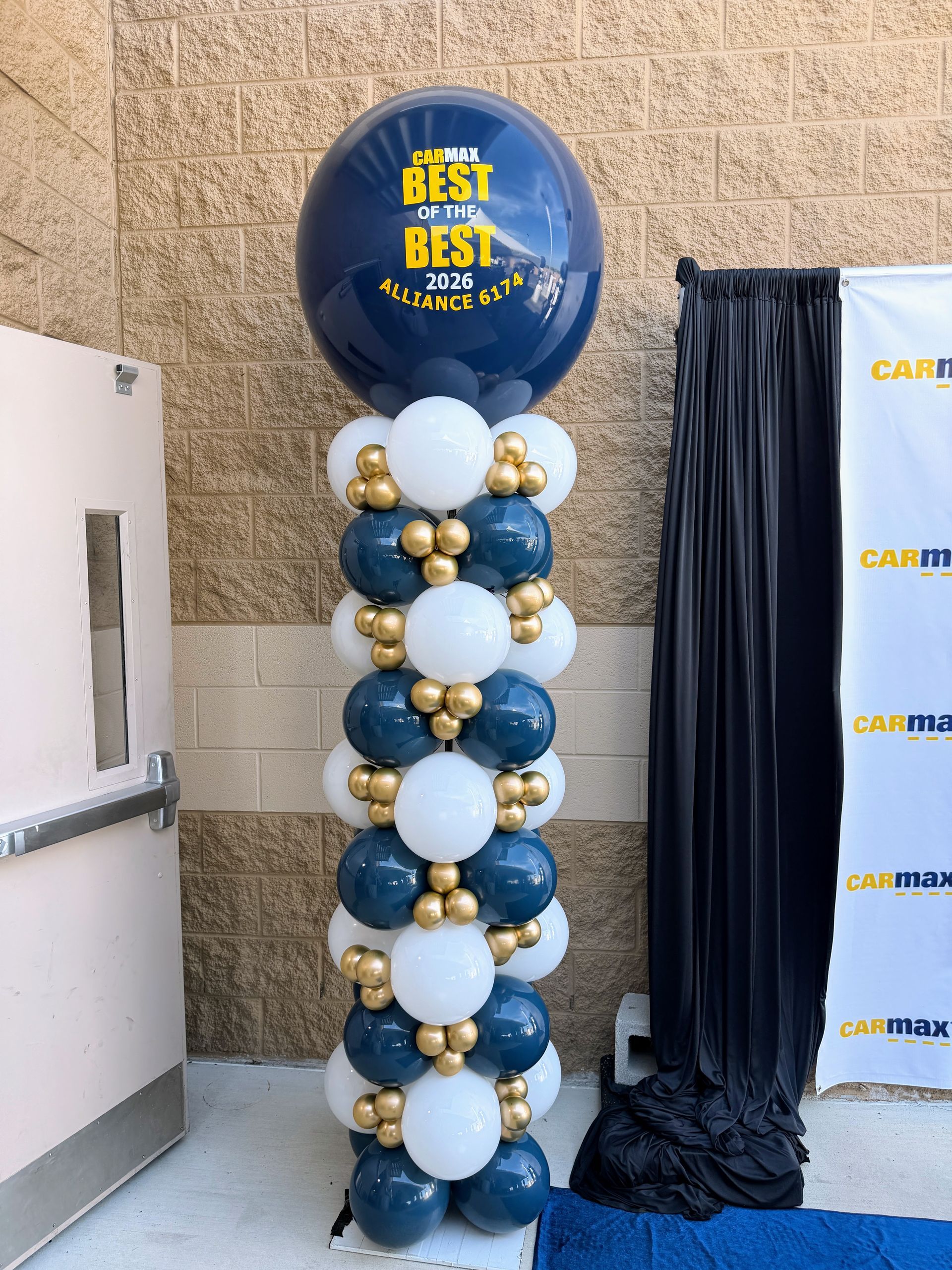 Corporate balloon column decor for Carmax in company colors and a company logo