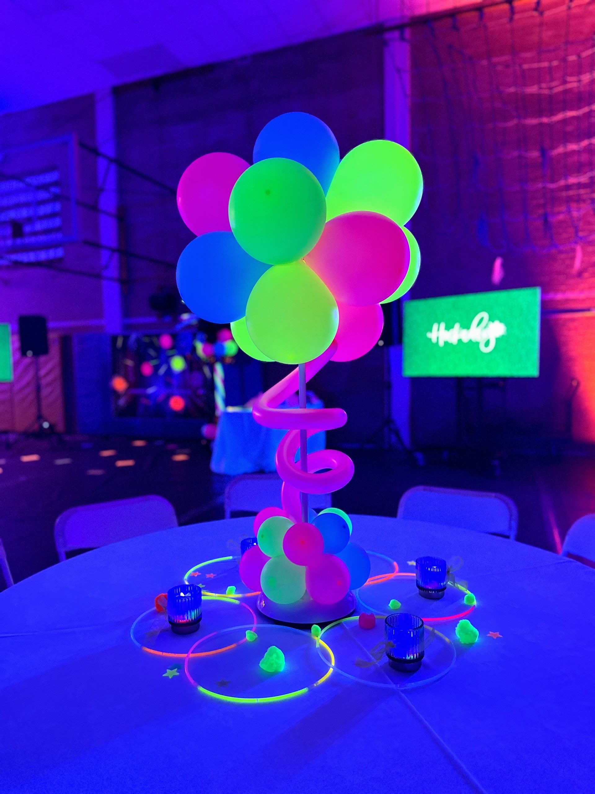 A table with glow in the dark balloons on it