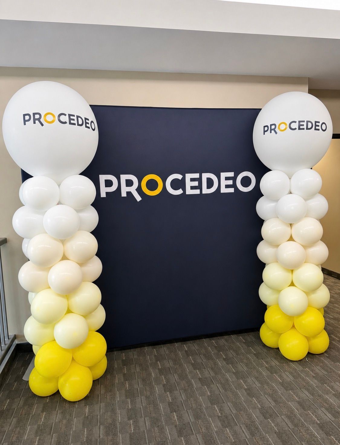 Corporate balloon column decor in company colors and a company logo