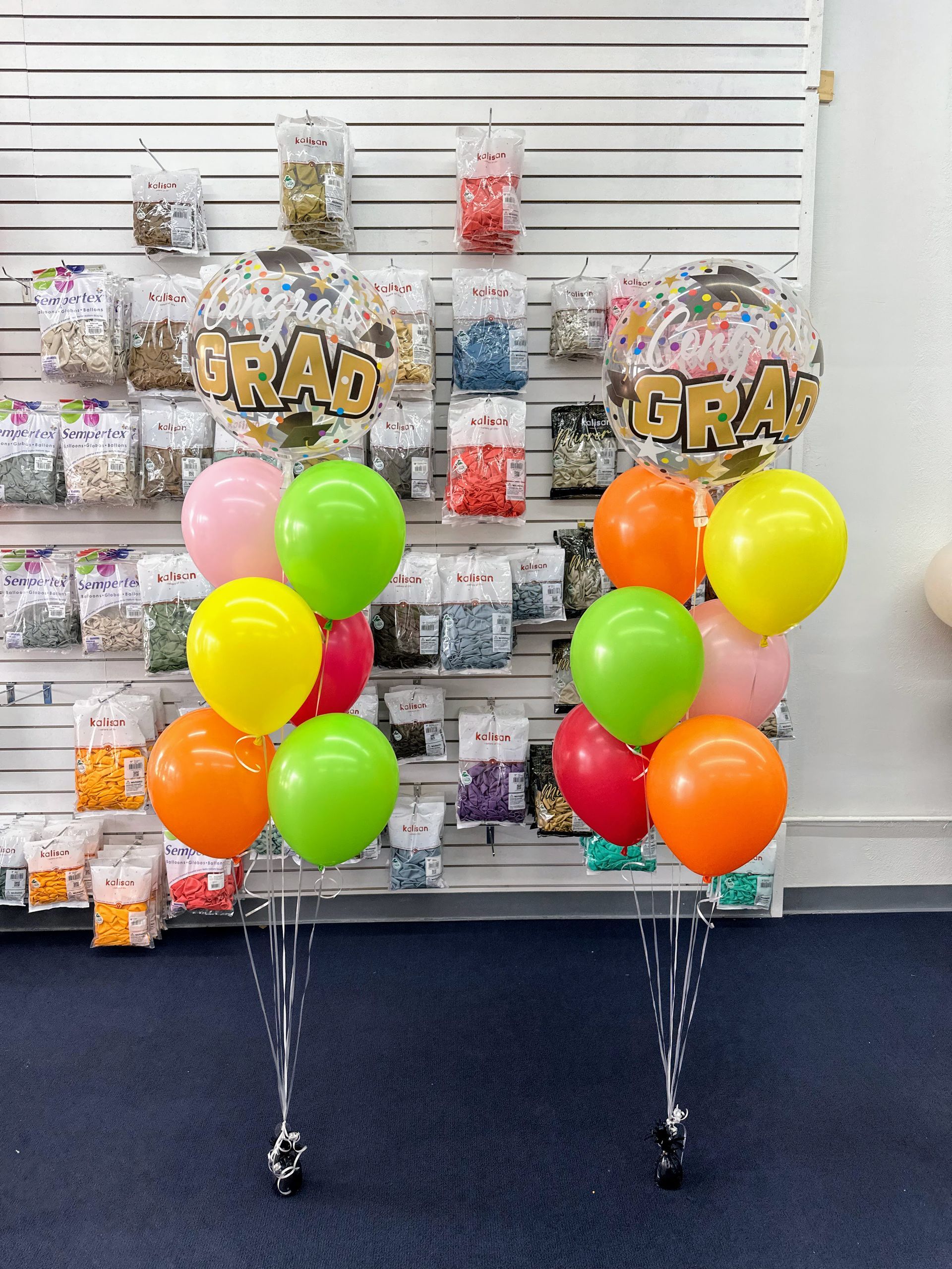 A bunch of balloons with the word graduation on them