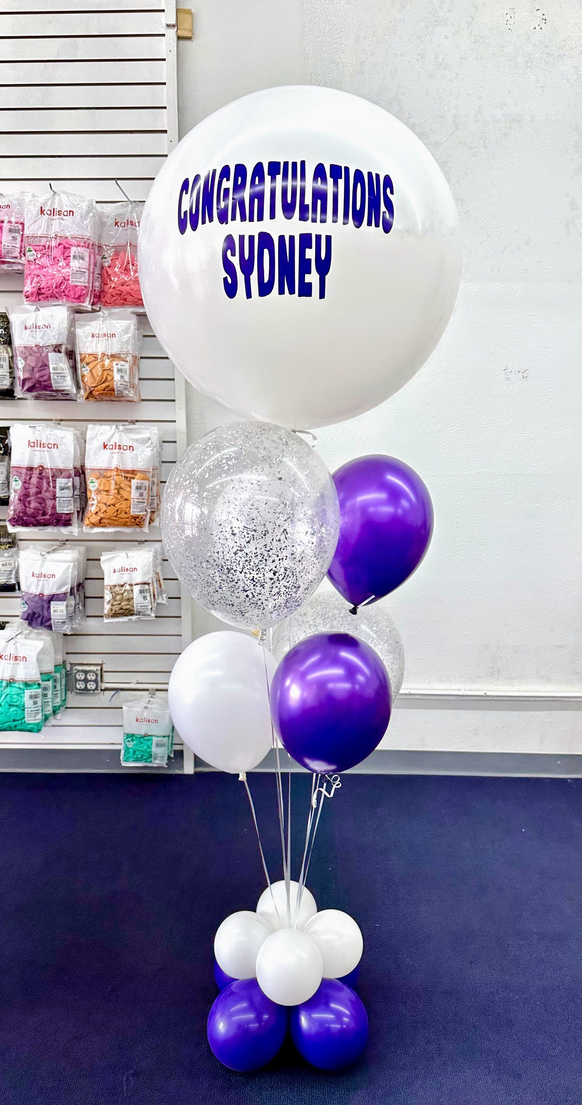 A bunch of balloons are sitting on top of each other in a room.