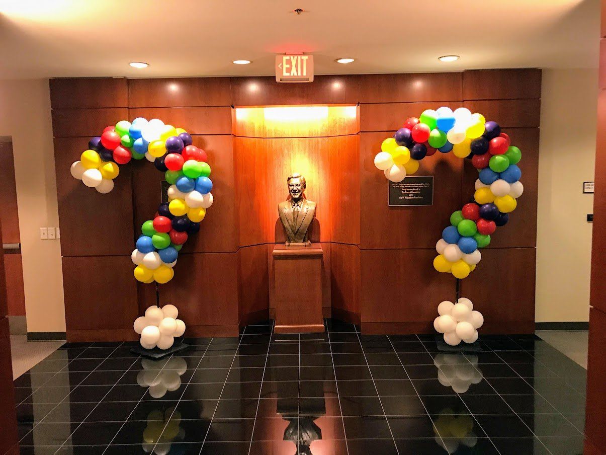 A room with balloons in the shape of a question mark
