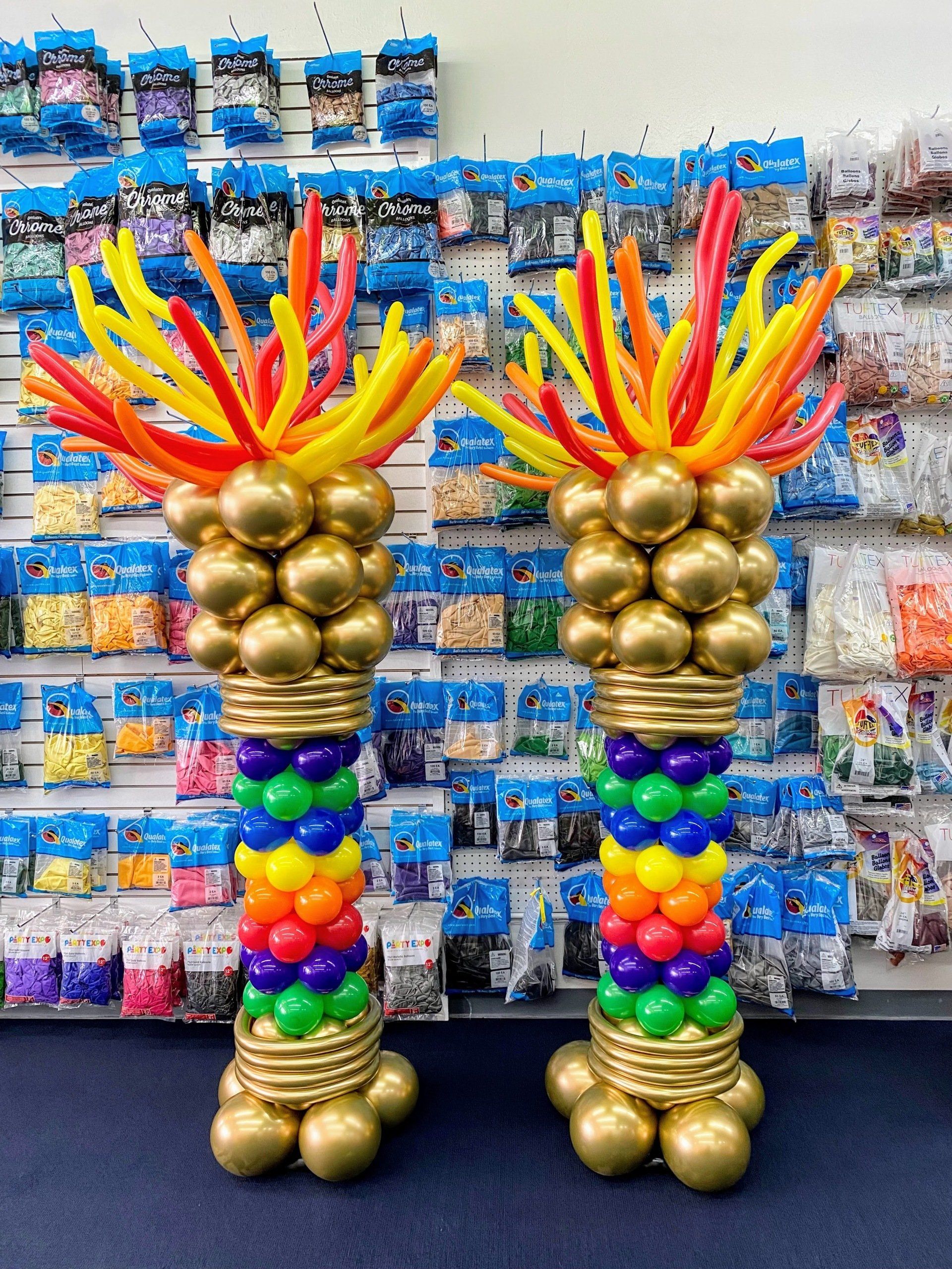 A couple of balloons standing next to each other in a store.