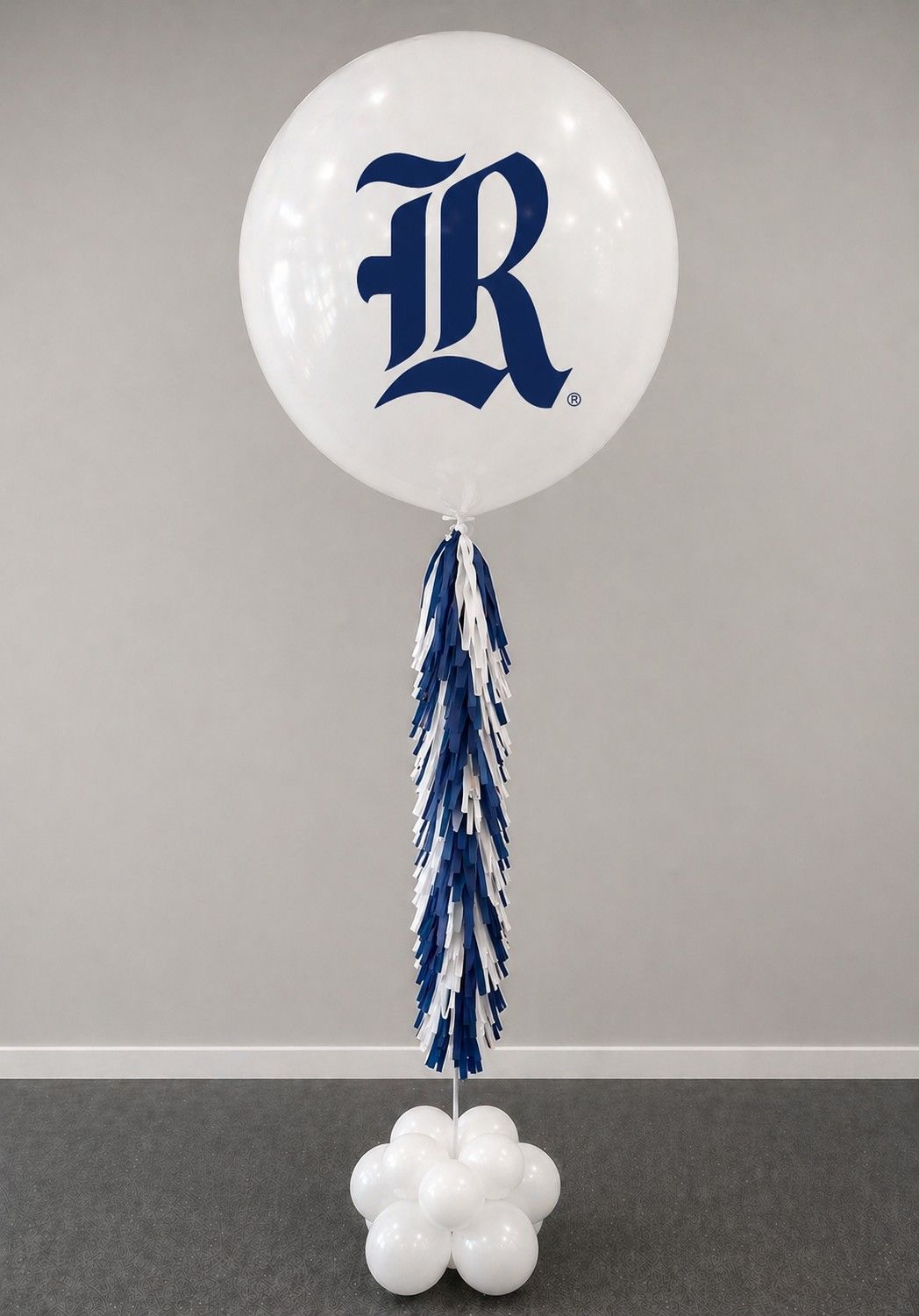 A jumbo helium balloon personalized with Rice university logo and color, with matching colored tassels..
