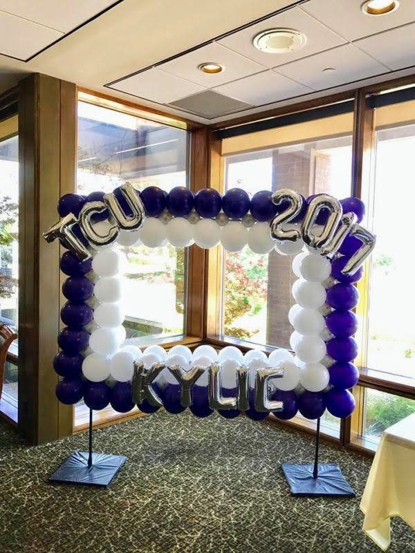 A picture frame made of balloons in a room.