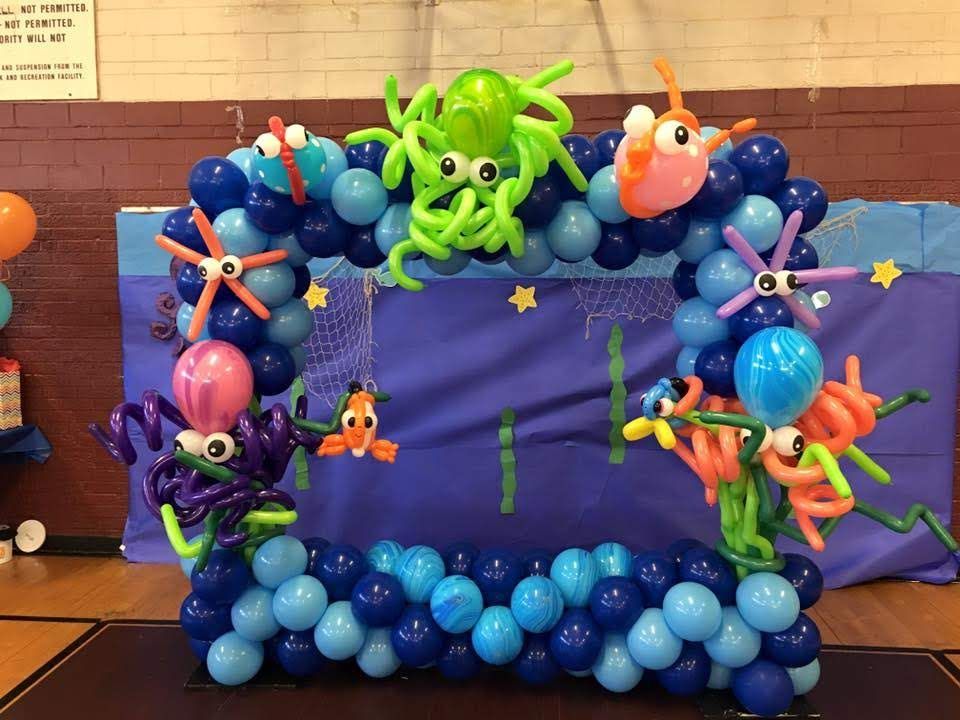 A picture frame made out of balloons with octopus and fish on it