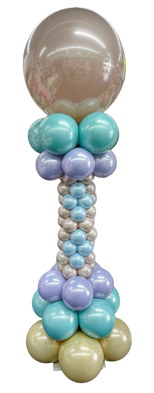 A bunch of gold balloons are stacked on top of each other on a white background.