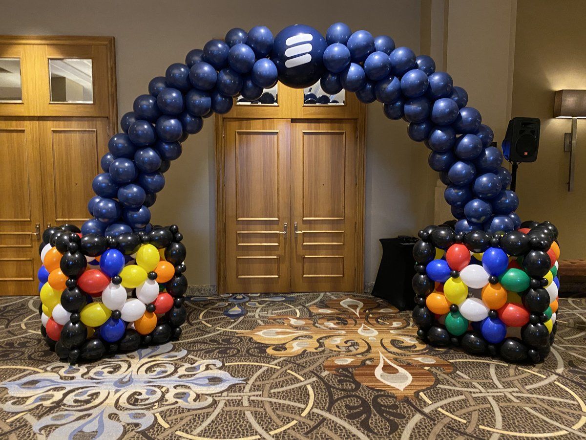 A large arch made of balloons in a room.