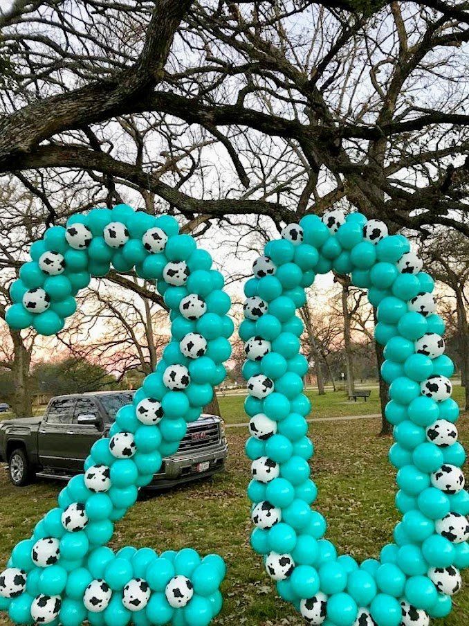 The number 20 is made of balloons and soccer balls.