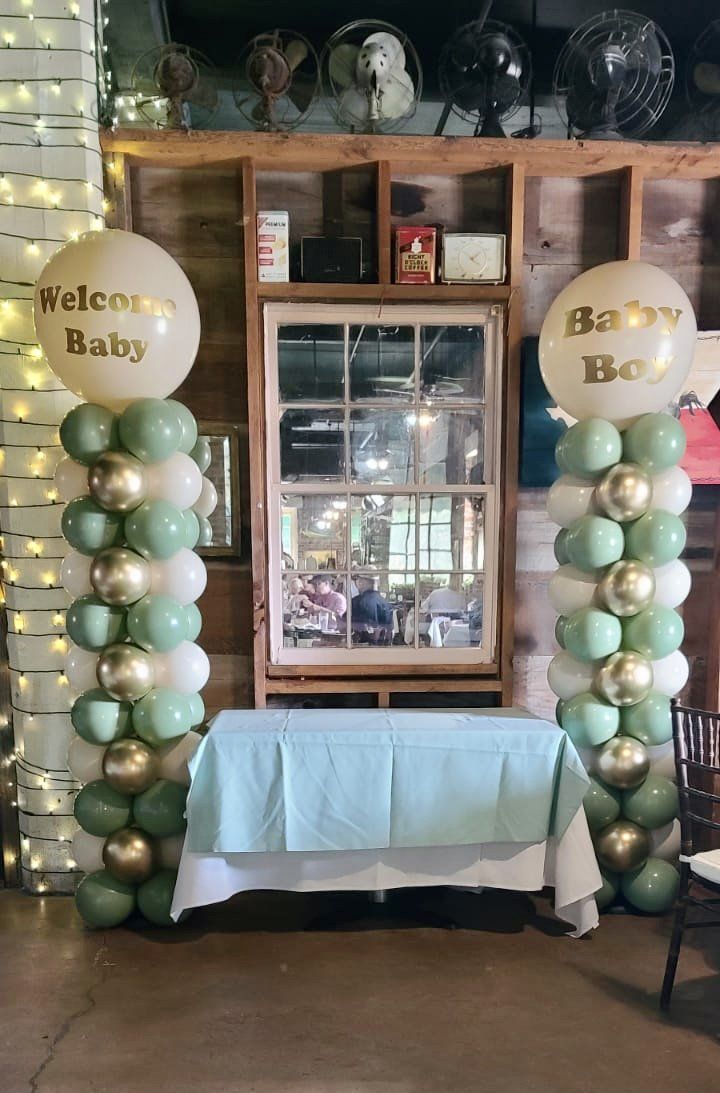 A room filled with balloons and a table.