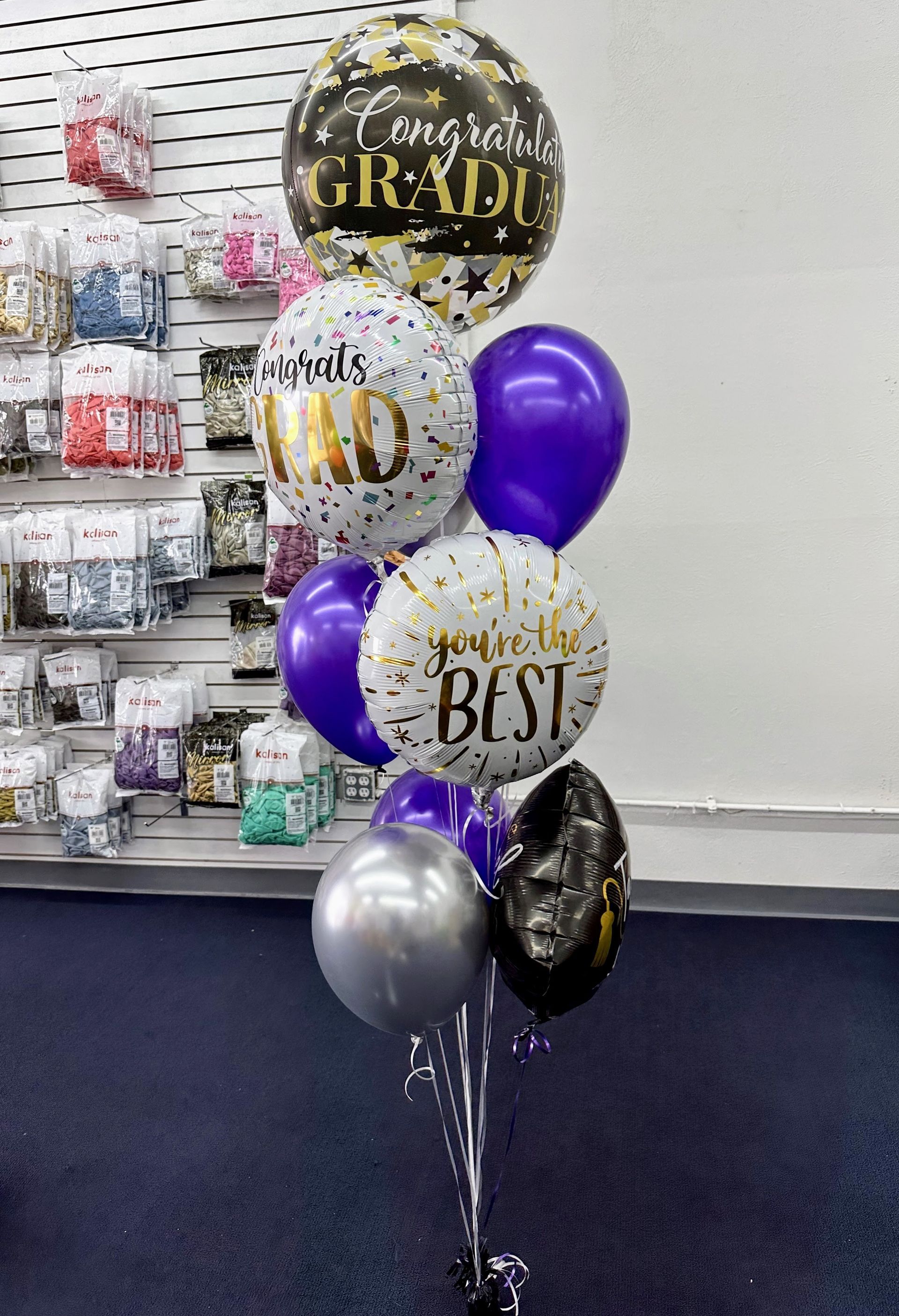 A bunch of balloons are sitting on a table in a room.